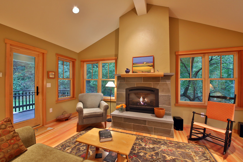 Inspiration for a craftsman enclosed light wood floor and beige floor living room remodel in Seattle with beige walls, a standard fireplace, a stone fireplace and no tv
