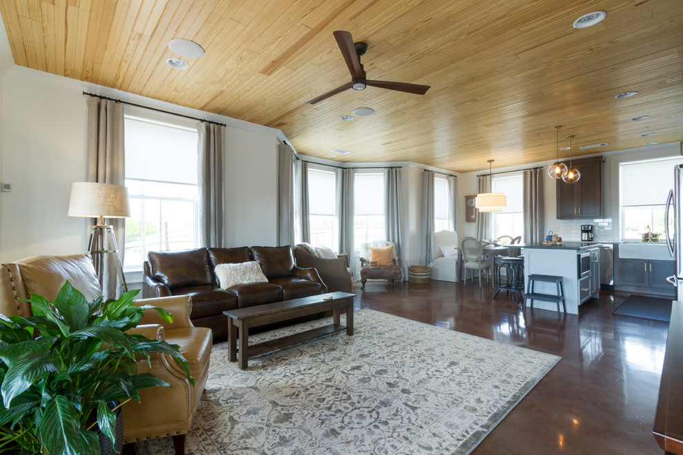 Foto di un soggiorno moderno di medie dimensioni e stile loft con pareti beige, pavimento in cemento, nessun camino e TV a parete