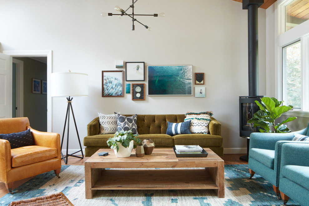 Inspiration for a transitional medium tone wood floor living room remodel in Boston with beige walls and a hanging fireplace