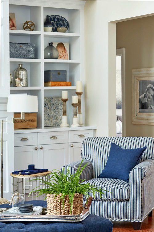 traditional living room with blue built in bookshelves and cream color scheme