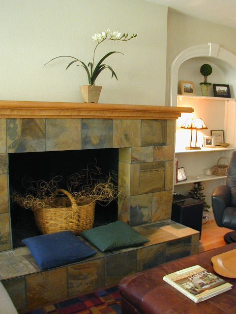 Example of a large trendy light wood floor living room design in Kansas City with beige walls, a standard fireplace and a tile fireplace
