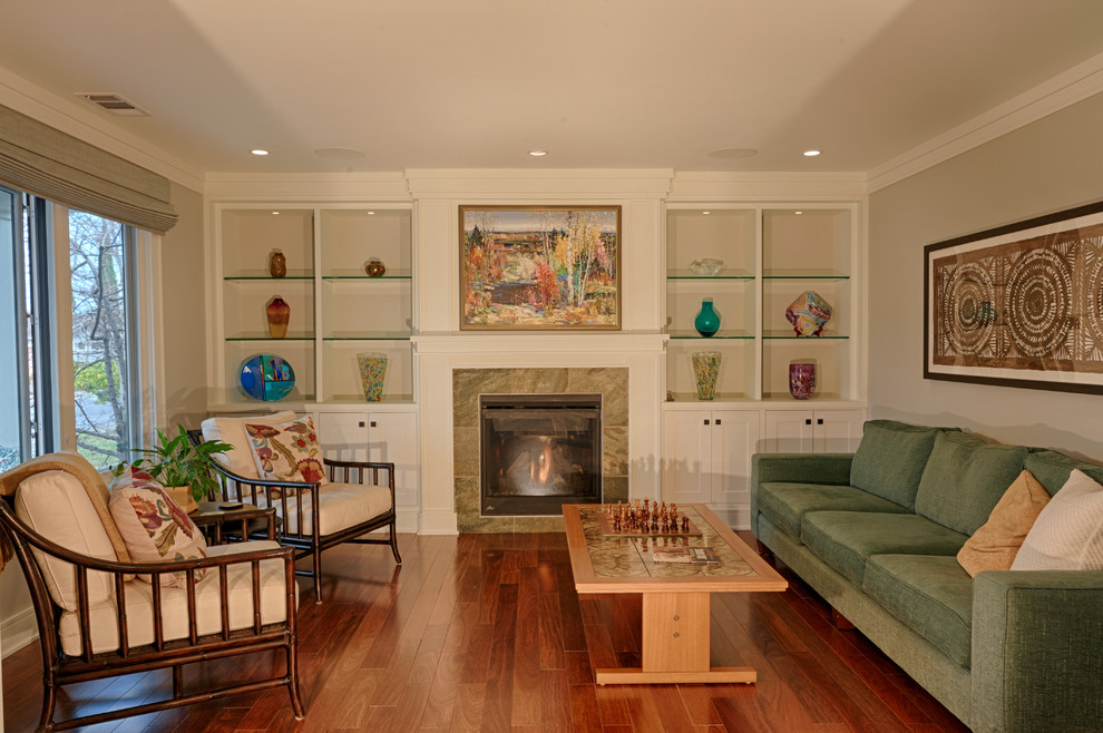 Example of a mid-sized arts and crafts formal and enclosed dark wood floor living room design in Raleigh with gray walls, a standard fireplace, a stone fireplace and a concealed tv