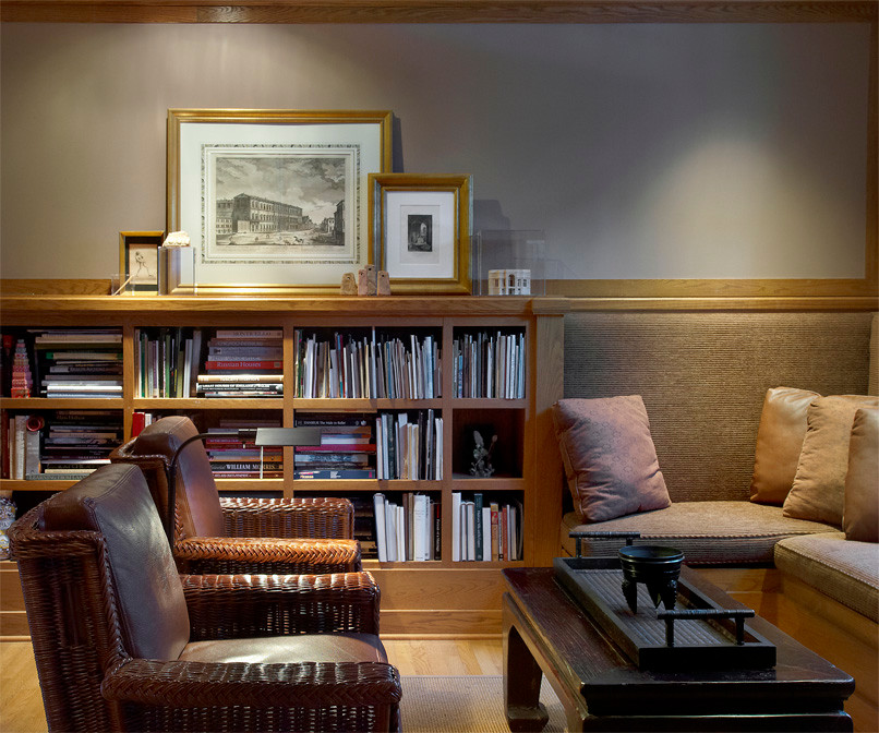 Example of an arts and crafts enclosed medium tone wood floor living room library design in Chicago with beige walls and no tv