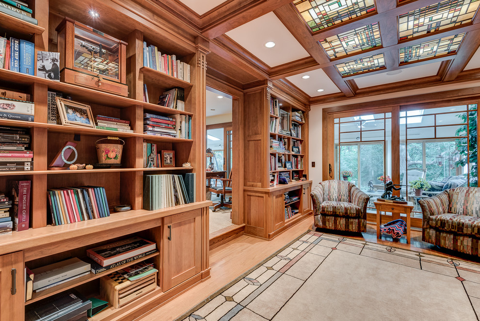 Large arts and crafts open concept light wood floor living room library photo in Chicago with beige walls, no fireplace and no tv