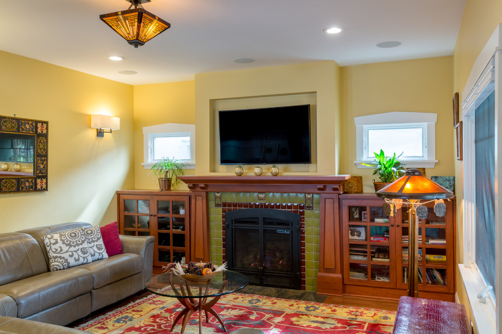 Example of a small arts and crafts open concept light wood floor living room design in San Francisco with a standard fireplace, a tile fireplace, yellow walls and a wall-mounted tv