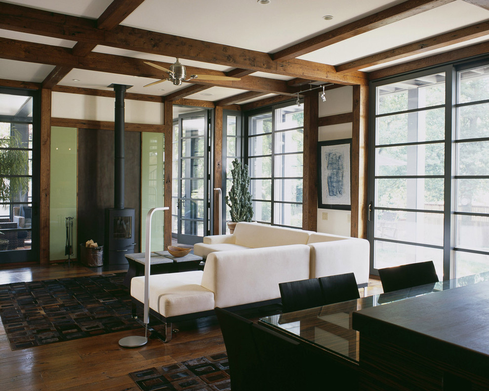Zen dark wood floor living room photo in DC Metro with a wood stove