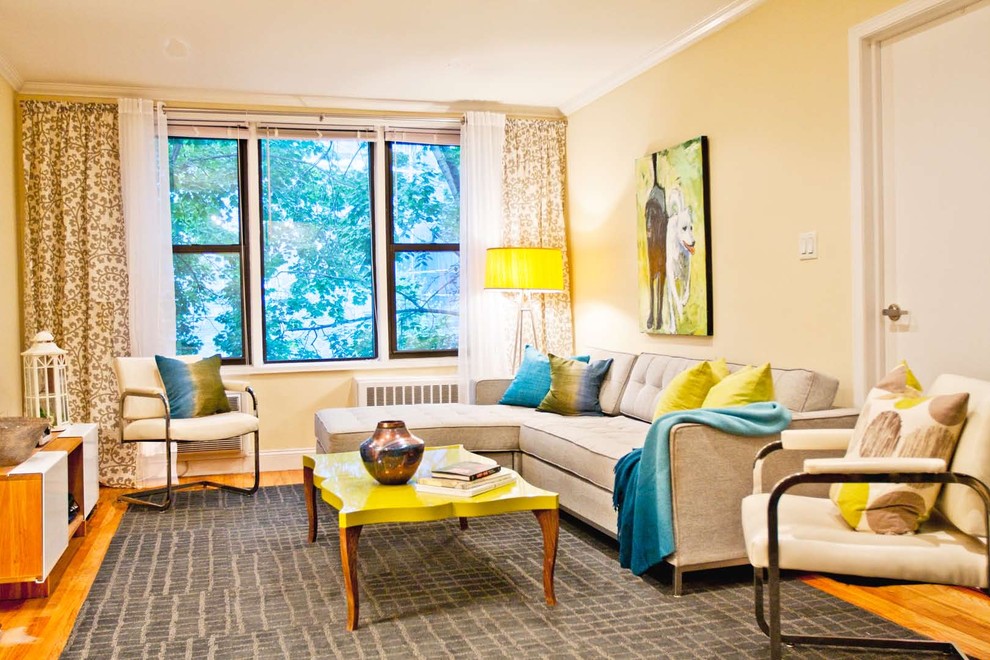 Inspiration for a mid-sized modern medium tone wood floor living room remodel in New York with beige walls