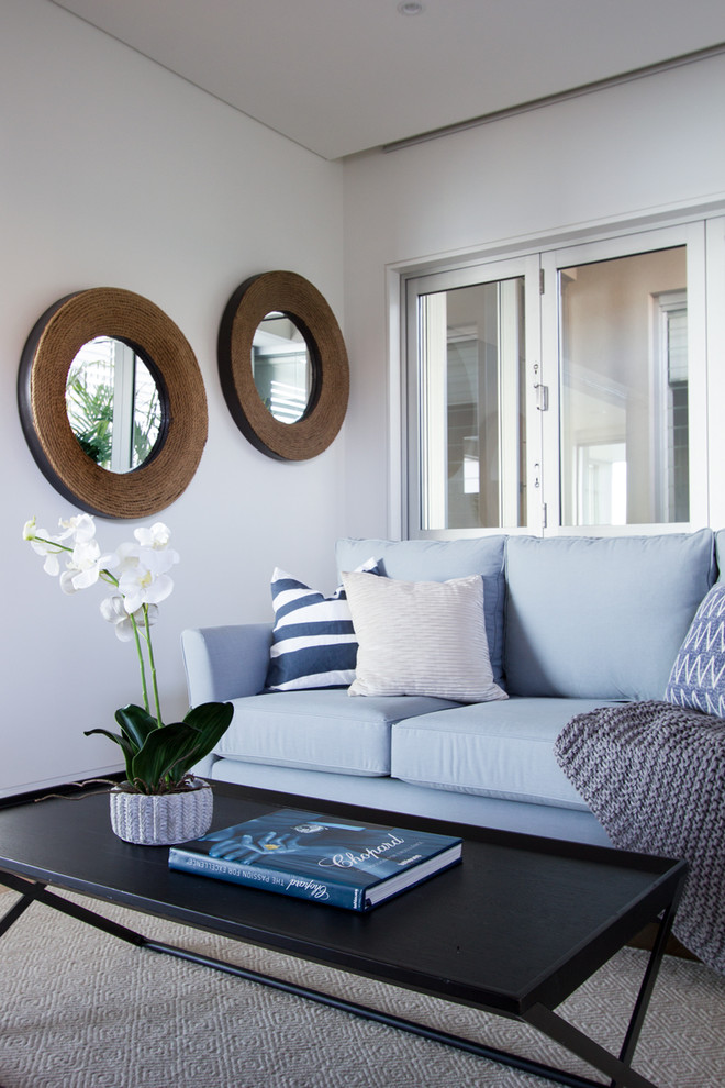 Example of a trendy open concept living room design in Sydney with white walls