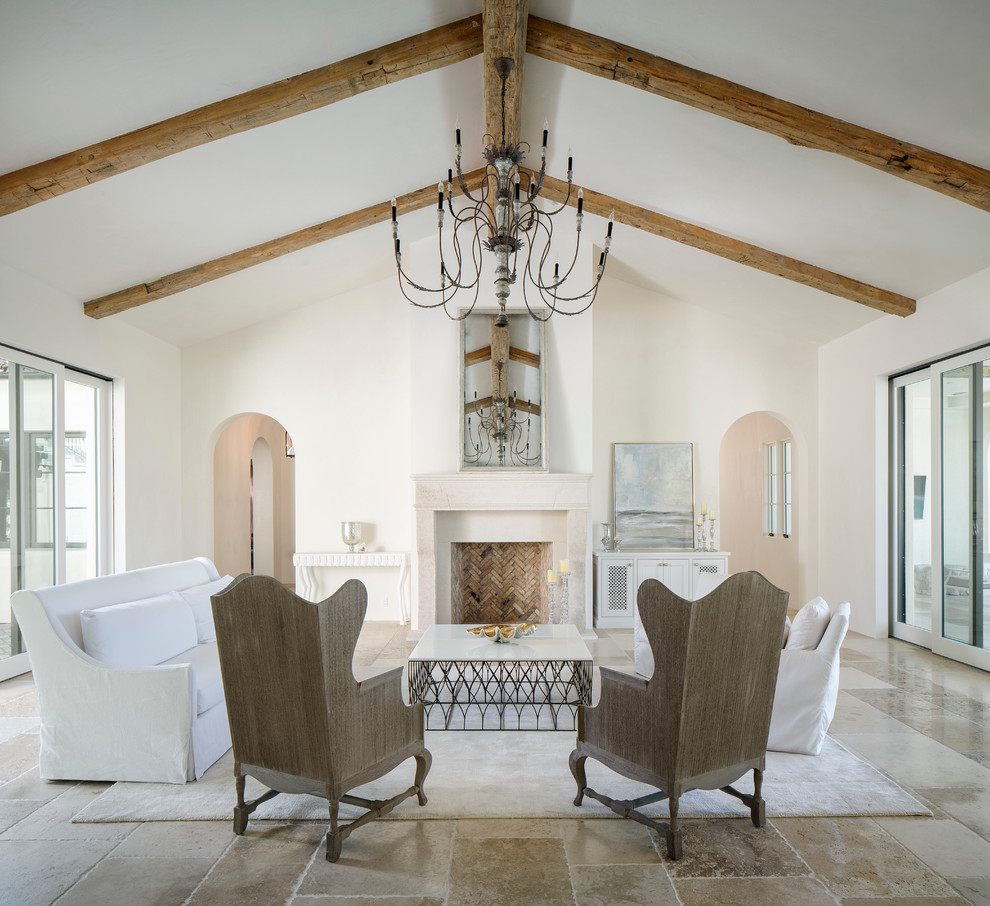 This is an example of a mediterranean formal open plan living room in San Diego with white walls and a standard fireplace.