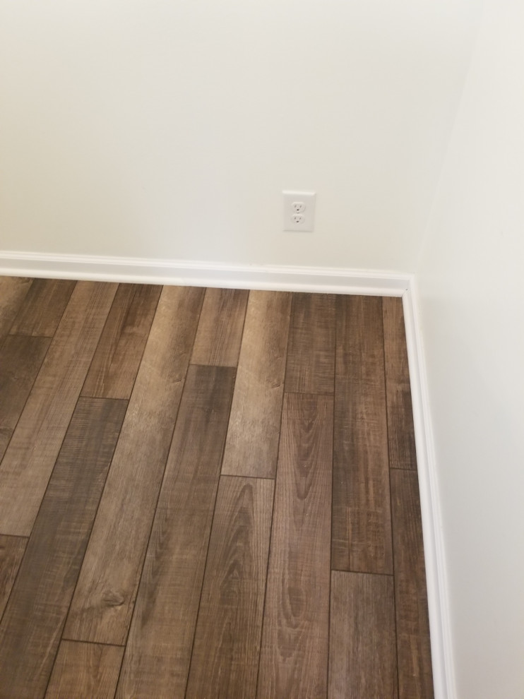 Immagine di un grande soggiorno minimalista con pavimento in vinile