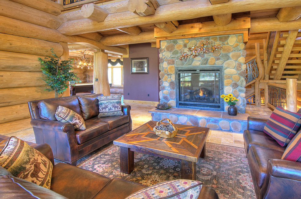 Photo of a large rustic open plan living room in Denver with brown walls, no tv, travertine flooring, a standard fireplace, a stone fireplace surround and beige floors.