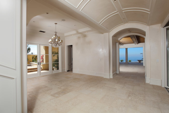 Inspiration for a mediterranean open concept porcelain tile living room remodel in Orange County with white walls