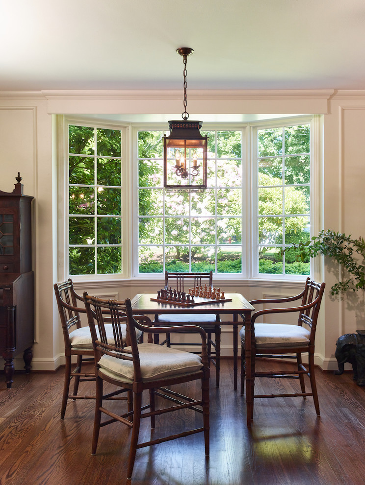 Ispirazione per una sala da pranzo chic di medie dimensioni con pareti bianche, parquet scuro, camino classico, cornice del camino in legno e pavimento marrone