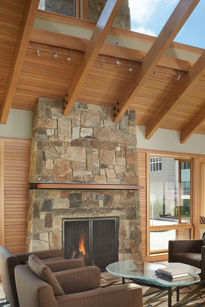 Inspiration for a contemporary living room remodel in Seattle with beige walls, a standard fireplace and a stone fireplace