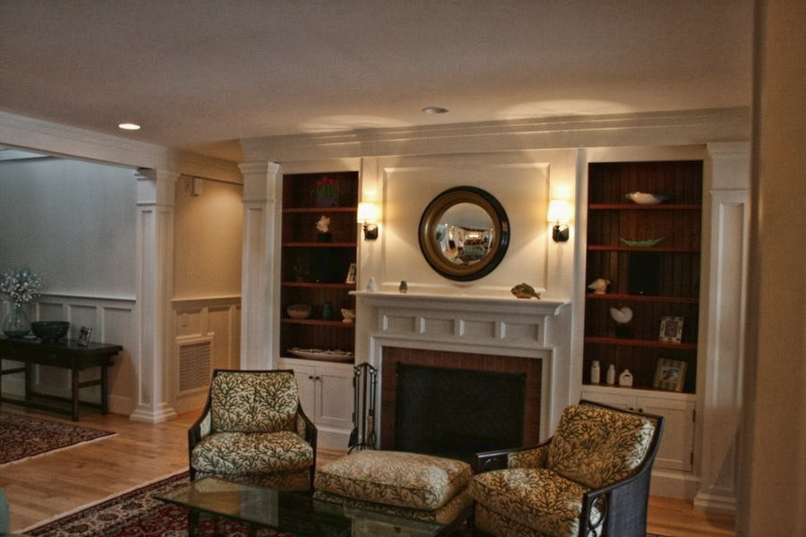 This is an example of a large nautical living room in Atlanta with beige walls, light hardwood flooring, a standard fireplace and a brick fireplace surround.