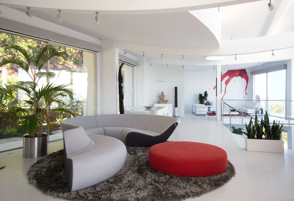 This is an example of an expansive contemporary mezzanine living room in San Francisco with white walls, no tv and white floors.