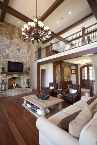 Inspiration for a large timeless formal and open concept dark wood floor living room remodel in Atlanta with beige walls, no fireplace, a stone fireplace and a wall-mounted tv