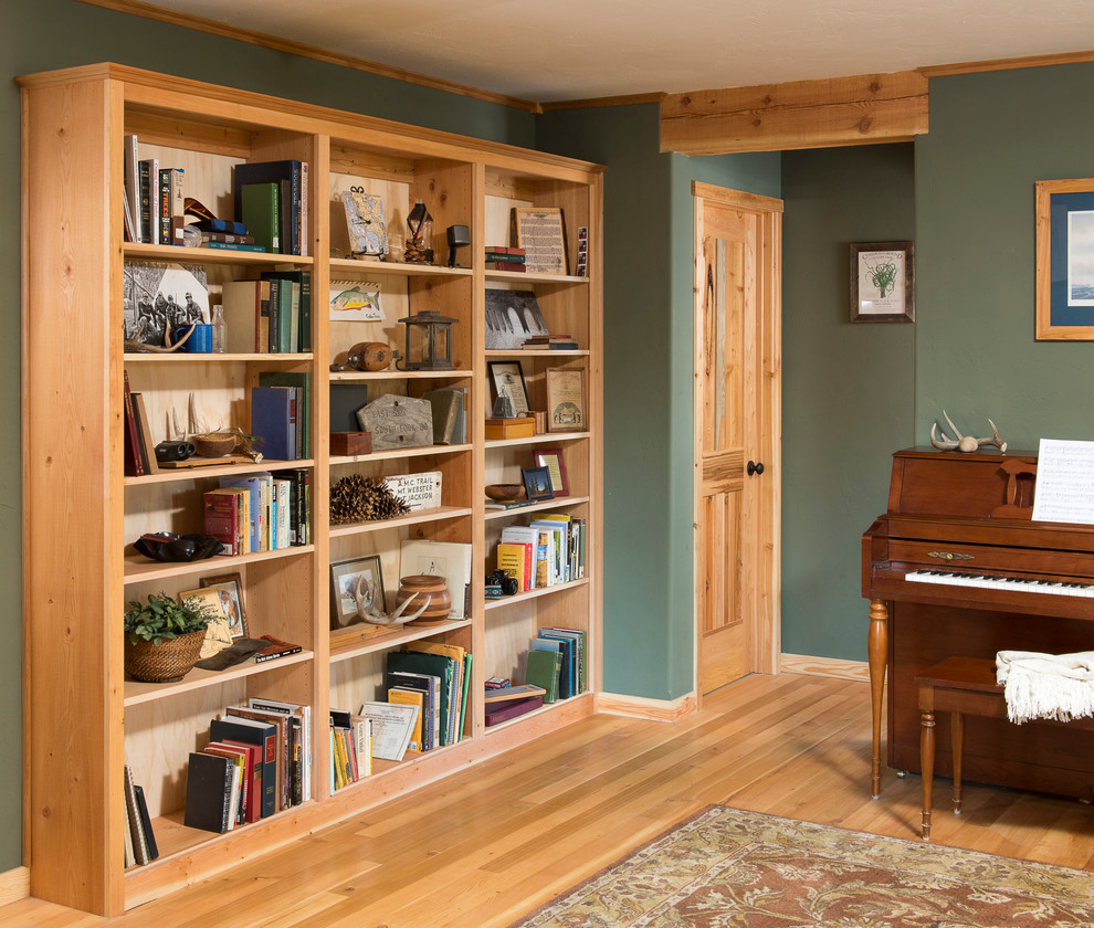 This is an example of a medium sized rustic open plan living room in Other with green walls and light hardwood flooring.