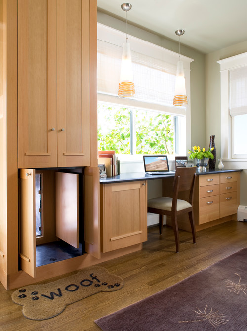 A hidden dog door is seamlessly built into the cabinetry, maintaining the room’s clean, custom look when not n use.