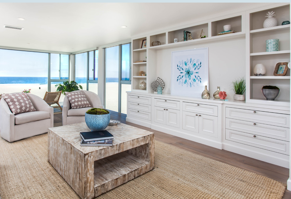Design ideas for a beach style formal open plan living room in Los Angeles with white walls, medium hardwood flooring and brown floors.