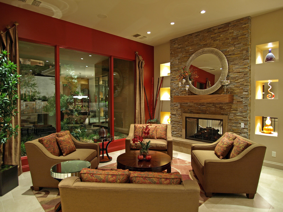 Idée de décoration pour un salon design ouvert et de taille moyenne avec une salle de réception, un mur rouge, un sol en carrelage de porcelaine, une cheminée double-face, un manteau de cheminée en pierre, aucun téléviseur et un sol beige.