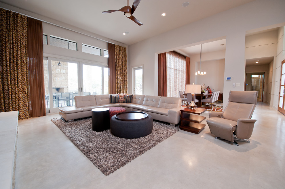 Contemporary living room in Austin with concrete flooring.