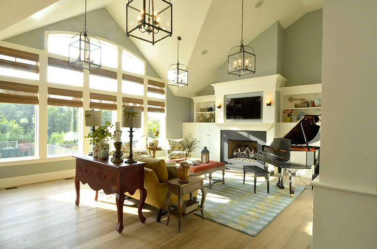 Large transitional open concept light wood floor and beige floor living room photo in Salt Lake City with a music area, beige walls, a standard fireplace, a concrete fireplace and a wall-mounted tv