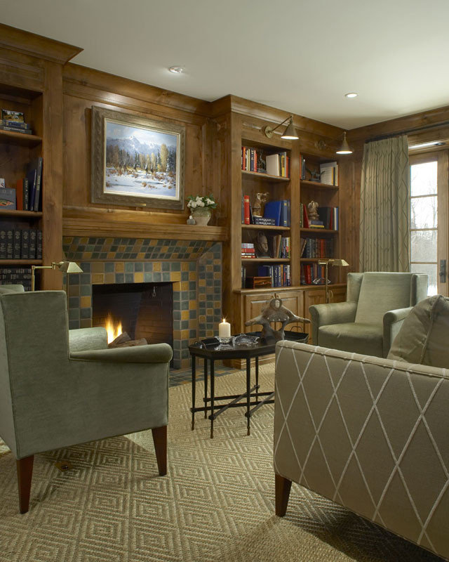 Photo of a large classic enclosed living room in Detroit with a reading nook, beige walls, carpet, a standard fireplace, a tiled fireplace surround, no tv and beige floors.