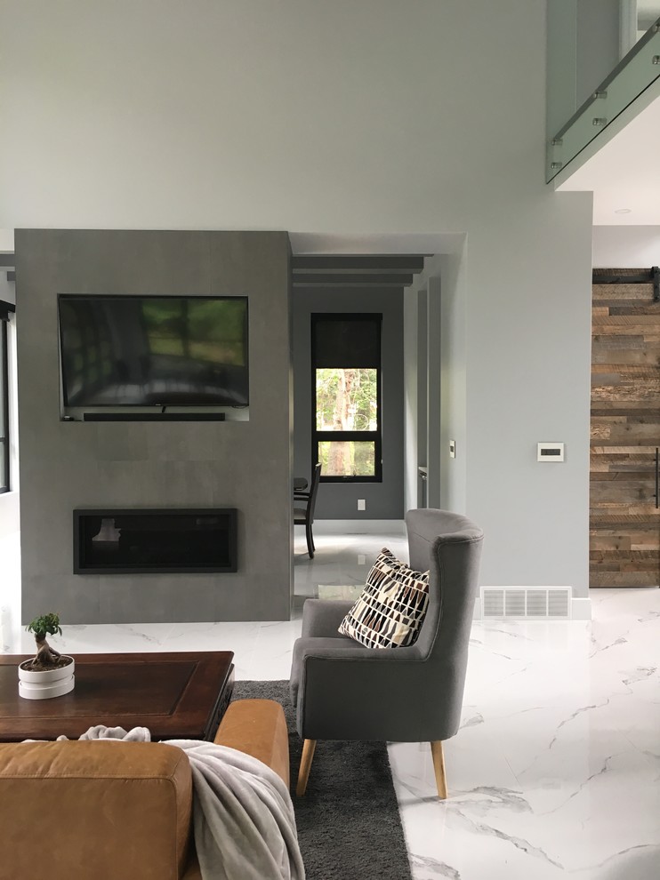 Living room - large modern formal and open concept ceramic tile and white floor living room idea in Edmonton with gray walls, a standard fireplace, a tile fireplace and a media wall