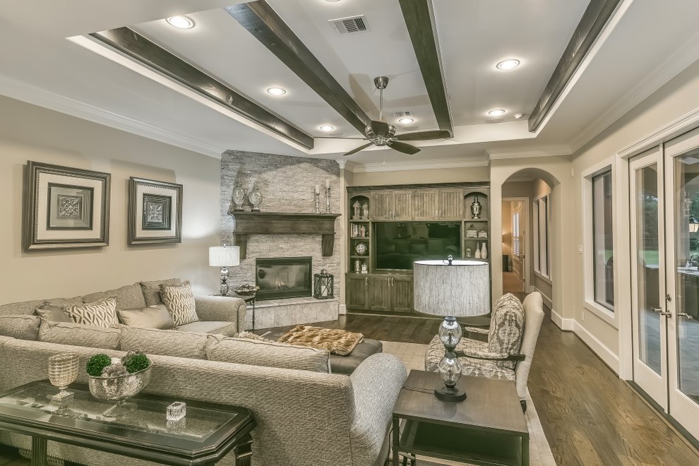 Example of a large transitional open concept medium tone wood floor living room design in Other with beige walls, a corner fireplace, a stone fireplace and a media wall