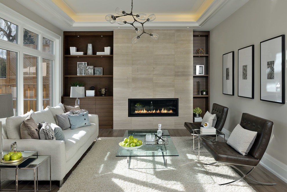Design ideas for a medium sized traditional living room in Toronto with a ribbon fireplace, a tiled fireplace surround and beige walls.
