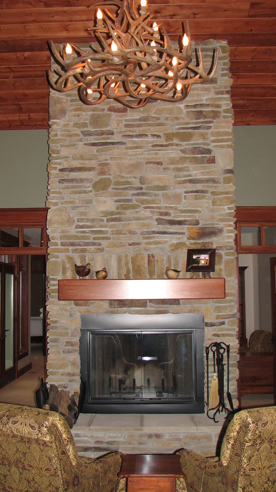 Mountain style living room photo in Chicago with a standard fireplace and a stone fireplace