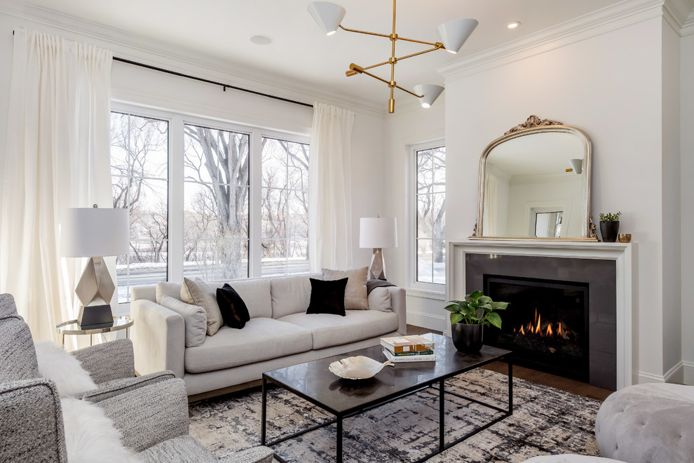 This is an example of a medium sized traditional open plan living room in Other with white walls, medium hardwood flooring and a standard fireplace.