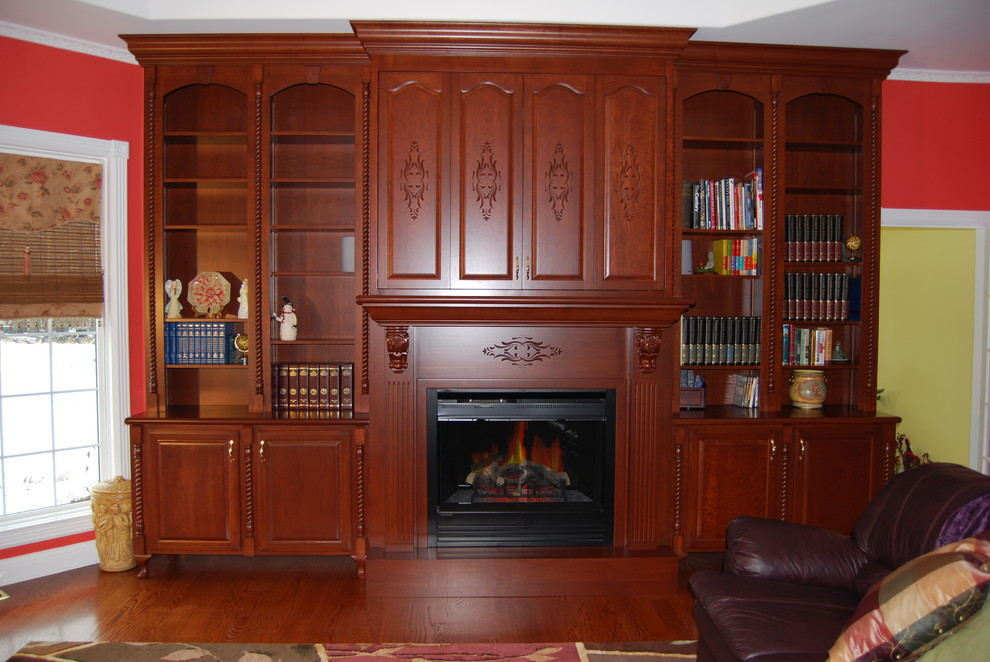 Medium sized retro formal open plan living room in Other with red walls, dark hardwood flooring, a standard fireplace, a wooden fireplace surround, a wall mounted tv and brown floors.