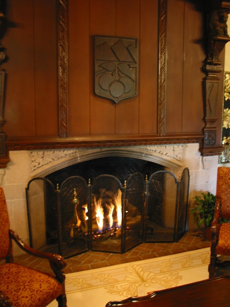 Traditional living room in Denver with a standard fireplace and a stone fireplace surround.