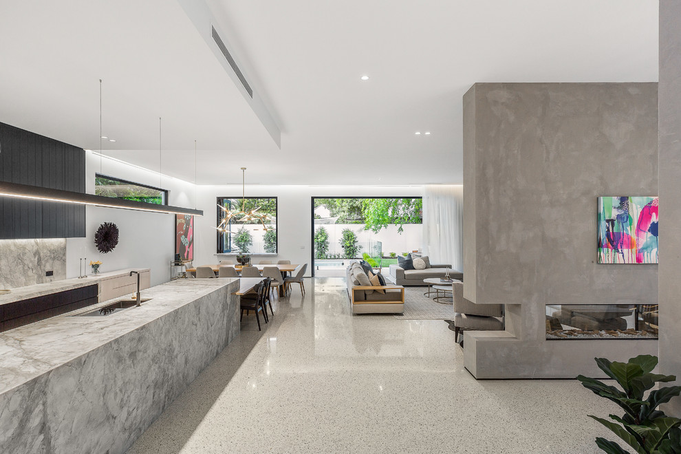 This is an example of a large contemporary open plan living room in Melbourne with white walls, concrete flooring, a two-sided fireplace, a concrete fireplace surround, a wall mounted tv and grey floors.