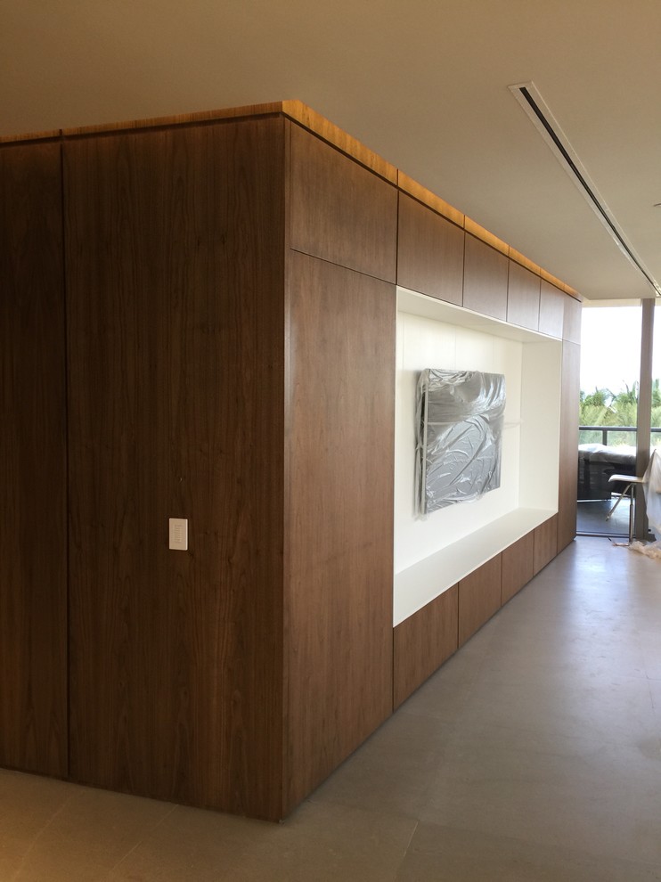 Modelo de salón abierto minimalista grande sin chimenea con paredes marrones y suelo gris