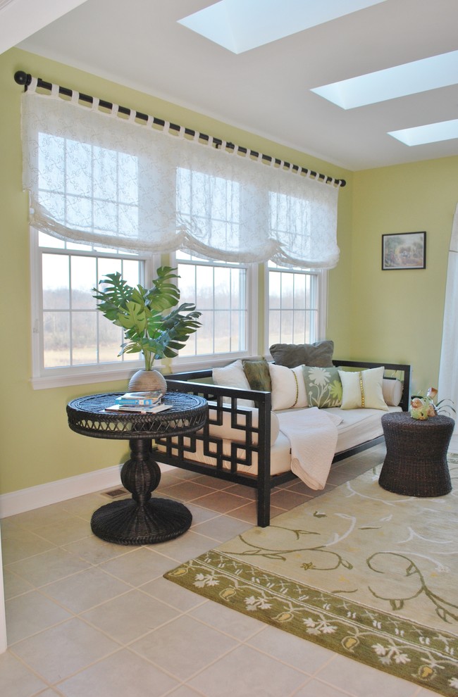 Example of a mid-sized island style enclosed ceramic tile living room design in New York with green walls