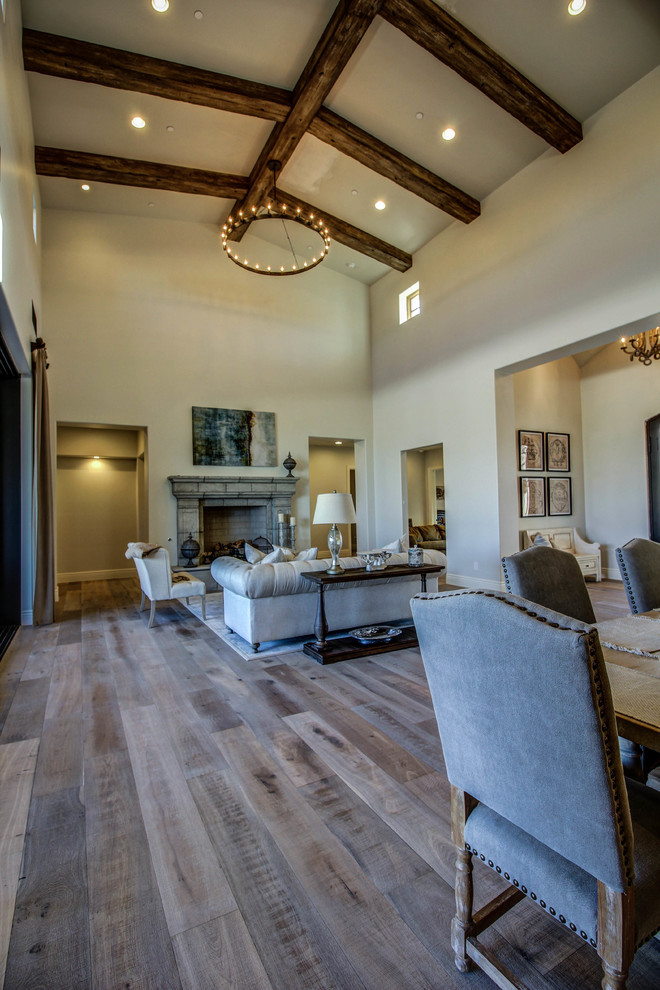 Inspiration for a mid-sized southwestern formal and open concept medium tone wood floor living room remodel in Phoenix with beige walls, a standard fireplace, a stone fireplace and no tv