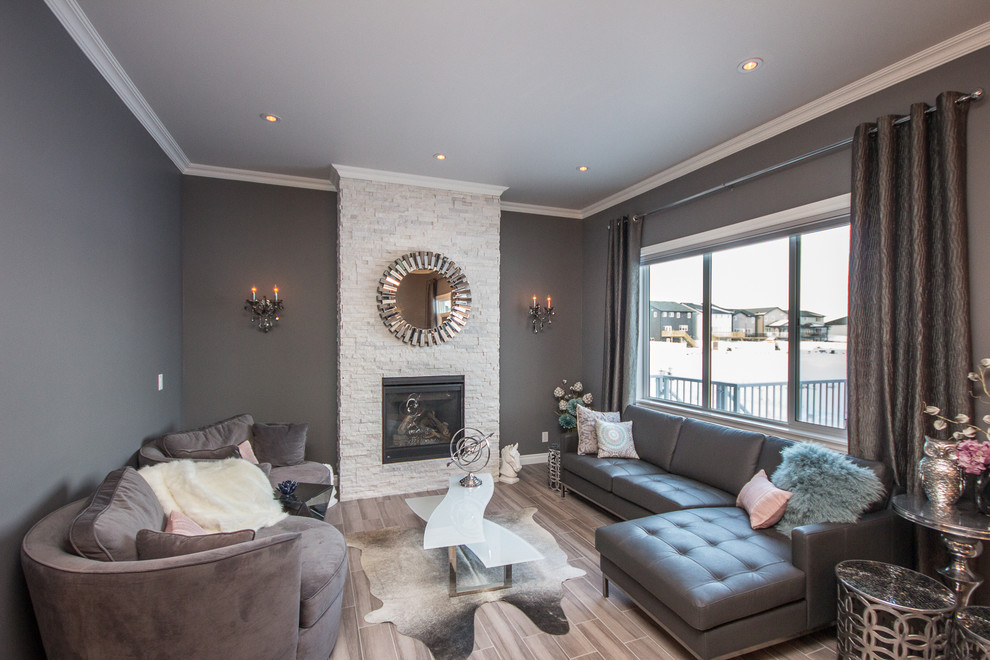Photo of a medium sized traditional formal enclosed living room in Calgary with grey walls, porcelain flooring, a standard fireplace and a stone fireplace surround.
