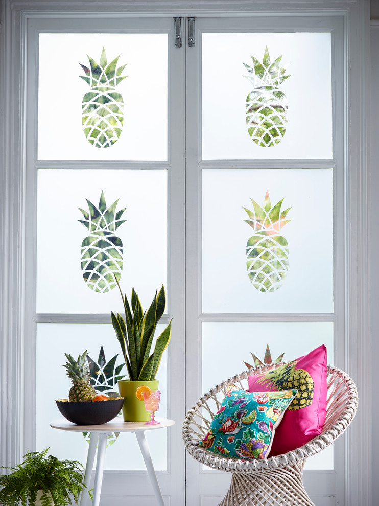 Inspiration for a tropical living room remodel in Buckinghamshire with white walls
