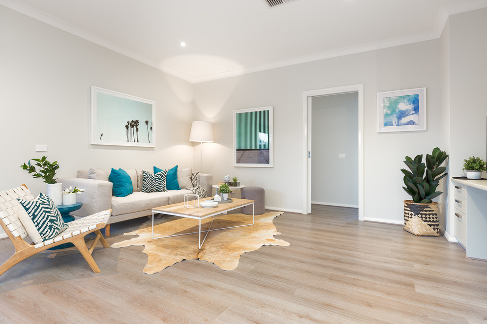 Contemporary grey and teal living room in Melbourne with grey walls, laminate floors and grey floors.