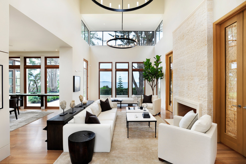 This is an example of a large contemporary living room in San Francisco with white walls and medium hardwood flooring.