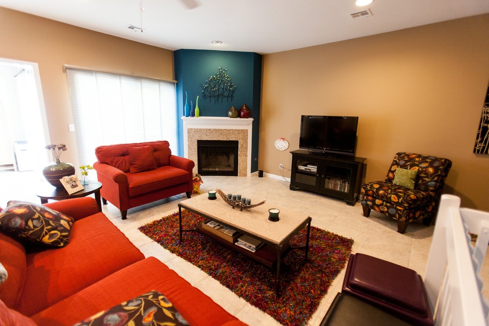 This is an example of a medium sized modern mezzanine living room in Kansas City with beige walls, ceramic flooring, a corner fireplace, a tiled fireplace surround, a freestanding tv and beige floors.
