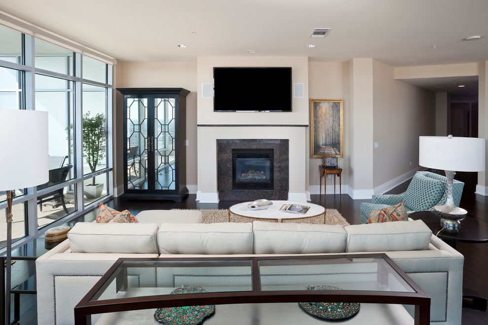 Inspiration for a transitional formal dark wood floor and brown floor living room remodel in Dallas with beige walls, a standard fireplace and a wall-mounted tv