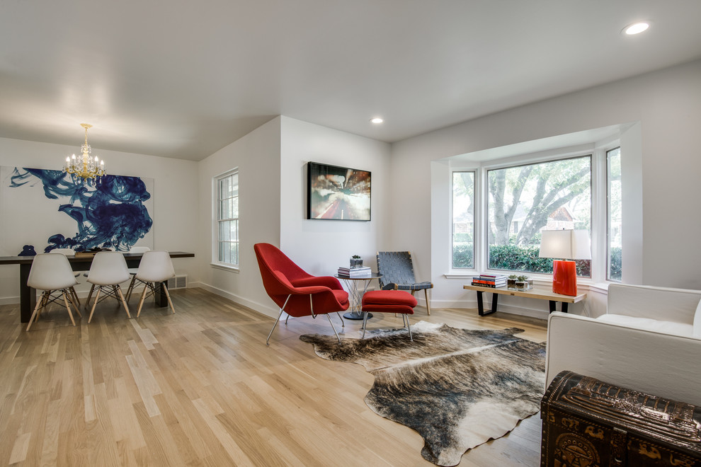 Example of a mid-sized danish formal and open concept light wood floor living room design in Dallas with white walls, no fireplace and no tv