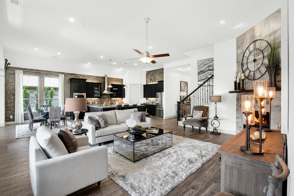 Example of a large trendy open concept dark wood floor and brown floor living room design in Dallas with white walls, a corner fireplace and a tile fireplace