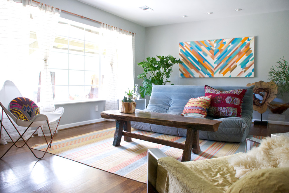 Bohemian living room in Dallas with grey walls and dark hardwood flooring.