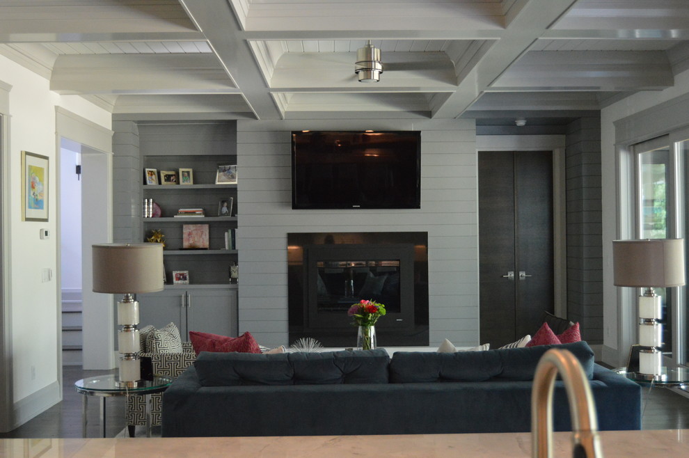 チャールストンにあるラグジュアリーな広いコンテンポラリースタイルのおしゃれなLDK (白い壁、濃色無垢フローリング、標準型暖炉、木材の暖炉まわり、壁掛け型テレビ) の写真