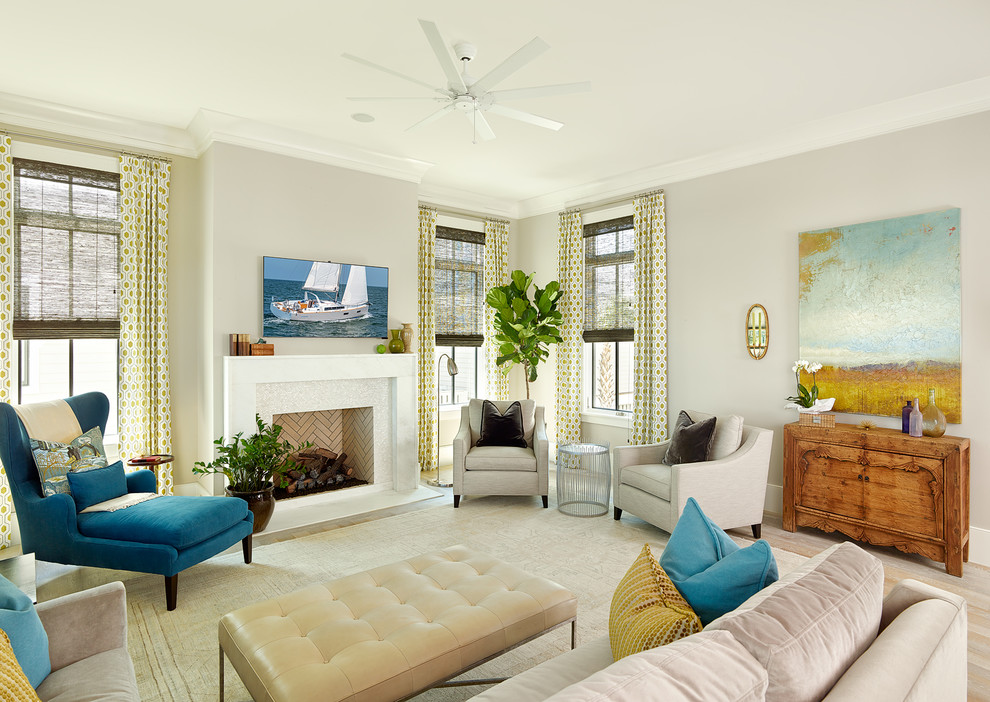 Maritimes Wohnzimmer mit grauer Wandfarbe, braunem Holzboden, Kamin und TV-Wand in Charleston